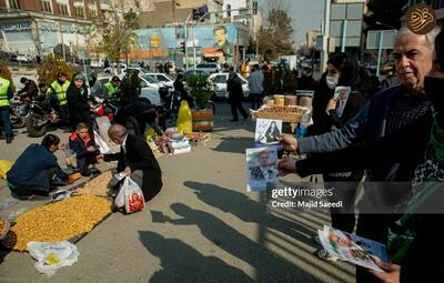 تصاویری جالب از توزیع عکس‌های نامزد‌های انتخابات مجلس در تهران
