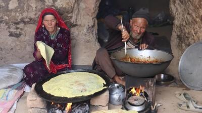پخت نان محلی ساجی و خورشت گوجه بادمجان توسط زوج افغان (فیلم)