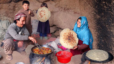 (ویدئو) فرآیند پخت یک غذای محلی با سیب زمینی توسط زوج جوان افغان در غار