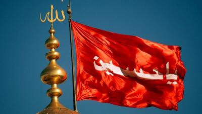 اهتزاز پرچم سرخ عاشورا بر فراز گنبد حرم حضرت معصومه(س)+ فیلم