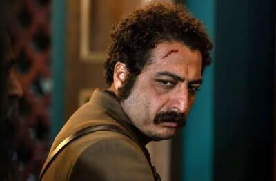 عکس هنری بازیگر شکارگاه در ترکیبی از نور و تاریکی