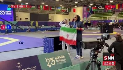  احترام نظامی ساینا کریمی و مهروز ساعی به پرچم ایران