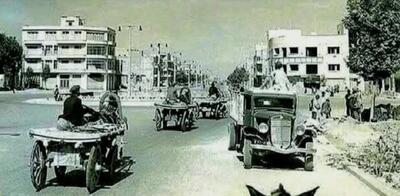  کامیون فورد و ارابه های اسبی در خیابان فردوسی تهران در سال ۱۳۱۲ (عکس)
