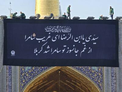  تعویض پرچم گنبد مطهر رضوی با نزدیک شدن به ایام عزاداری امام هادی(ع)