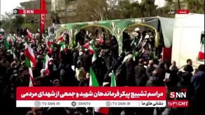  تبرک کردن پارچه و چفیه به تابوت شهدا در آیین تشییع پیکر فرماندهان شهید و شهدای مردمی